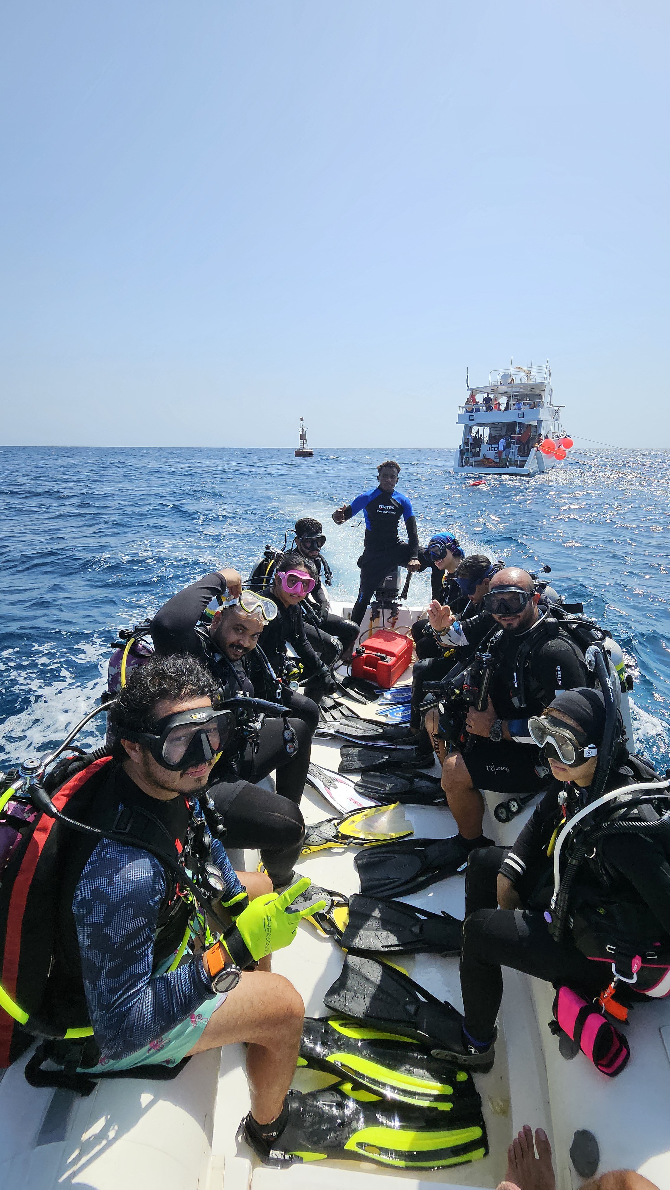 Certified scuba divers geared up on a boat before a guided dive trip in Jeddah