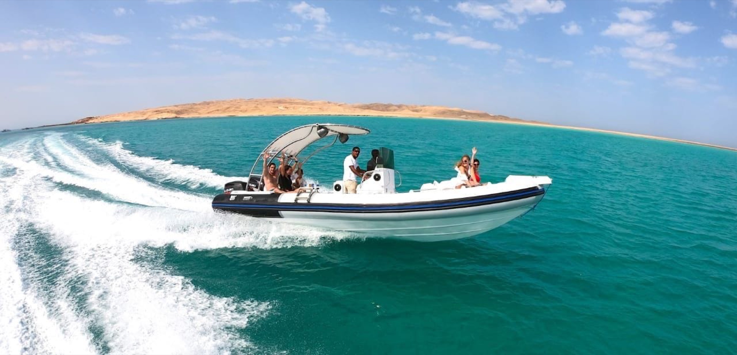 A Daily Red Sea speedboat carrying guests across clear Red Sea water